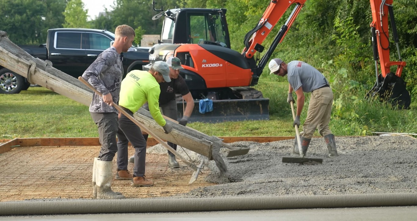 Commercial concrete crew pouring and finishing a large flatwork project